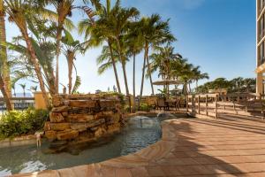 a water slide in a resort with palm trees at Holiday Inn Club Vacations Sunset Cove Resort in Marco Island