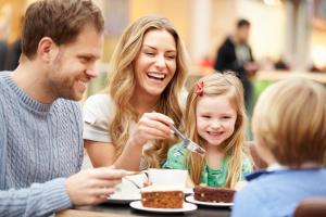 a family sitting at a table eating cake at Holiday Inn Club Vacations Sunset Cove Resort in Marco Island