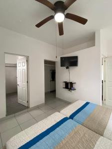a bedroom with a bed with a ceiling fan at DEPARTAMENTOS GARI in Córdoba