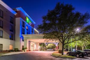 a hotel with a tree in front of a building at Holiday Inn Express Hotel & Suites Tampa-Anderson Road-Veterans Exp by IHG in Tampa