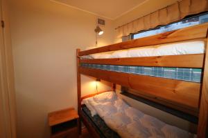 two bunk beds in a small room with a lamp at RIBO Apartment Riksgränsen in Riksgränsen