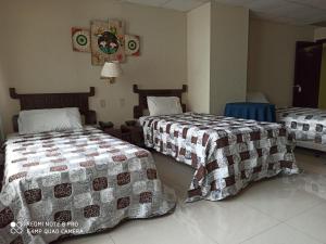 
A bed or beds in a room at Hotel Sol de Oriente
