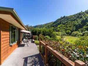 a porch of a house with a view of a mountain at Sawmillers Retreat - Arrowtown Holiday Home in Arrowtown