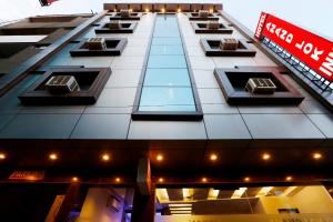 a tall building with windows on the side of it at Hotel Anand Lok Inn in New Delhi