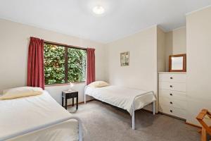 a bedroom with two beds and a window at Sycamore Place - Wanaka Holiday Home in Wanaka