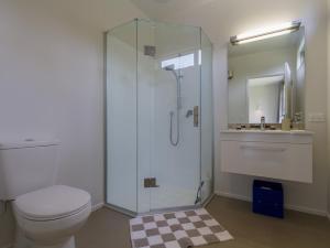 a bathroom with a shower and a toilet and a sink at Sunhaven Lakeside - Cromwell Holiday Home in Cromwell