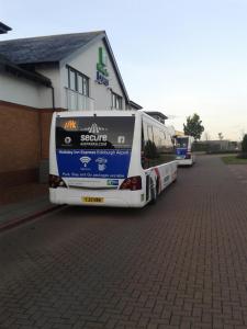 a double decker bus parked on the side of a road at Holiday Inn Express Edinburgh Airport, an IHG Hotel in Ingliston
