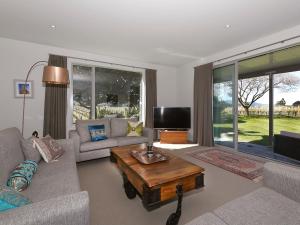 a living room with a couch and a coffee table at Marlborough Magic - Rapaura Holiday Home in Blenheim