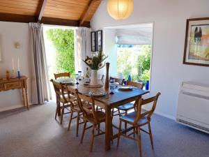 a dining room with a wooden table and chairs at Anchor in Akaroa - Akaroa Holiday Home in Akaroa