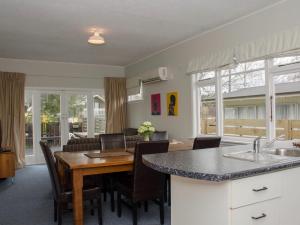a kitchen and dining room with a table and chairs at Scarborough Sweetie - Hanmer Springs in Hanmer Springs