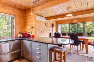 a kitchen and dining room with a table and chairs at Lakeside Landing - Lake Tarawera Holiday Home in Lake Tarawera