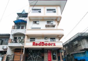 a building with a red book sign in front of it at RedDoorz @ PIY Margal Sampaloc Manila in Manila