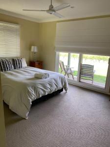 a bedroom with a large bed and a large window at Molly Morgan Vineyard in Rothbury