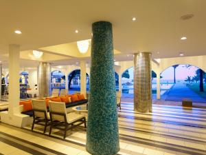 a lobby with a couch and chairs and a column at Trinco Blu by Cinnamon in Trincomalee