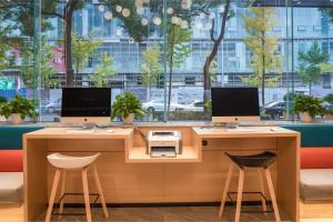 two desks with two monitors and a printer at Holiday Inn Express Ningbo City Center by IHG in Ningbo