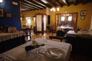 a restaurant with two tables with white table cloth at Hotel Casa Valero in Jarque de la Val