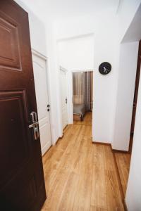 an open door to a room with a hard wood floor at Park Residence in Bacău