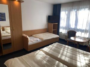 Voodi või voodid majutusasutuse Mirage City Hotel Stuttgart Zentrum toas