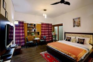 a bedroom with a large bed and a dining room at Golden Homestay in New Delhi