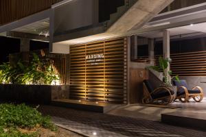 a lobby with two chairs in front of a building at Harding Boutique Hotel in Ahangama