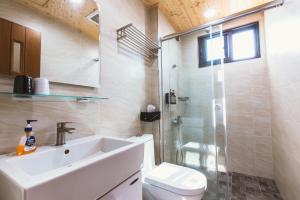 a bathroom with a toilet and a sink and a shower at Coolbreeze homestay in Huxi