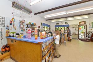 a young child standing at the counter of a store at Rondout Valley Camping Resort Deluxe Park Model 3 in Accord