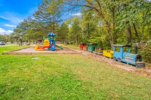 a playground with a toy train on the grass at Rondout Valley Camping Resort Deluxe Park Model 3 in Accord