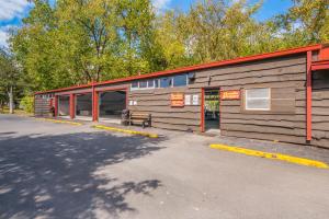 a wooden building with a bench in front of it at Rondout Valley Camping Resort Deluxe Park Model 3 in Accord