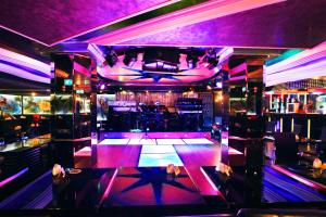 a nightclub with a bar with purple lighting and a dance floor at Gulf Inn Hotel Deira Formerly City Star Hotel in Dubai