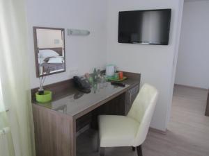 a room with a desk with a mirror and a chair at Villa Tollazzi in Logatec +45 photos