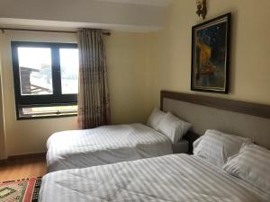 Voodi või voodid majutusasutuse Ngoc Tran Hotel toas