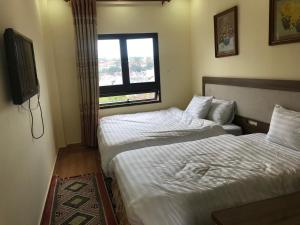 Voodi või voodid majutusasutuse Ngoc Tran Hotel toas