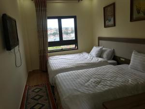 Voodi või voodid majutusasutuse Ngoc Tran Hotel toas