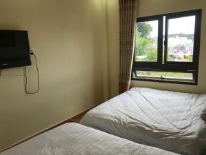 Voodi või voodid majutusasutuse Ngoc Tran Hotel toas