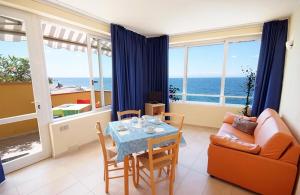 a living room with a table and a couch at Appartamenti - Villa Mare in Pomonte