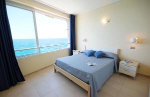 a bedroom with a bed with a view of the ocean at Appartamenti - Villa Mare in Pomonte