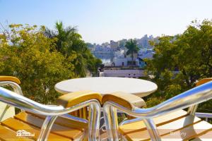 a table and chairs with a view of a city at 5BR Rajkarn Boutique Villa by 29Bungalow in Udaipur