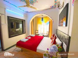 a bedroom with a bed with a red blanket at 5BR Rajkarn Boutique Villa by 29Bungalow in Udaipur