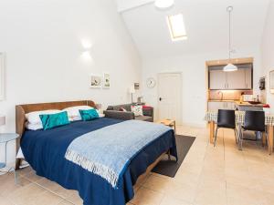 
a bedroom with a bed and a desk at Ships Mews in Porlock

