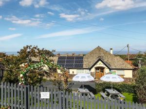 a house with solar panels on top of it at Ships Mews in Porlock