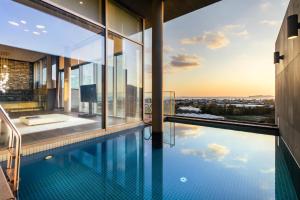 an infinity pool in a house with a view at Bayhill Pool & Villa in Seogwipo