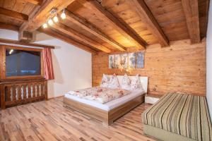 a bedroom with a bed and a tv in a room at Camping Inntal in Wiesing