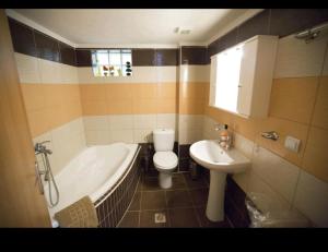 Eri Apartment 2 في كيراموتي: حمام مع حوض ومرحاض ومغسلة