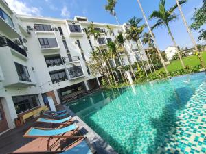 a swimming pool in front of a building at Mad Monkey Hoi An in Hoi An