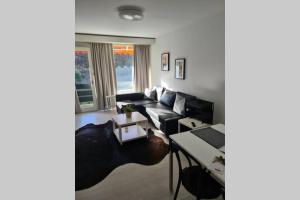 a living room with a couch and a table at Jutta Deluxe Apartment #301 in Bad Reichenhall