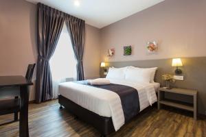 a hotel room with a large bed and a window at DK Hotel in Johor Bahru