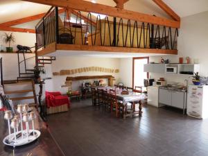 a large kitchen and dining room with a table in a room at Maison d'Hôtes des 2 Chênes in Bessenay
