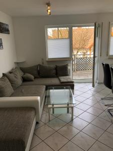 メッケンベウーレンにあるLandhaus Monikaのリビングルーム(ソファ、ガラスのコーヒーテーブル付)