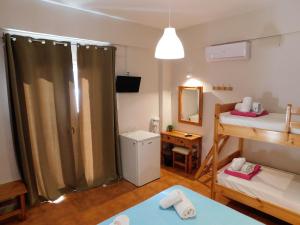 a small room with two beds and a mirror at Perdika Mare Guesthouse in Perdika