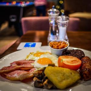 a plate of breakfast food on a table at La Ville Hotel in Alderney